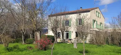 an old white house with green windows and trees at Chambre d'hôte chez l'habitant à la campagne in Cambounet-sur-le-Sor