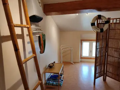 a room with bunk beds and a table and a ladder at Chambre d'hôte chez l'habitant à la campagne in Cambounet-sur-le-Sor
