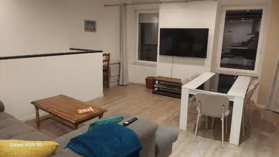 a living room with a couch and a flat screen tv at Le duplex sigeannais in Sigean