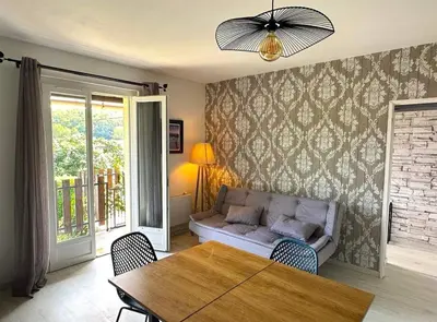 a living room with a couch and a table at Gîte Tintinnabule in Ventenac