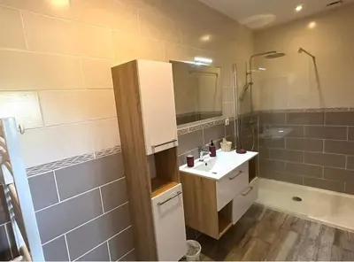 a bathroom with a white sink and a shower at Gîte Tintinnabule in Ventenac