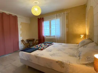 a bedroom with a large bed and a window at Maison avec 2 appartements, jacuzzi et accès privé à la rivière in Ladern-sur-Lauquet