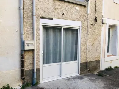a white door on the side of a building at La Barbacane in Lapalme