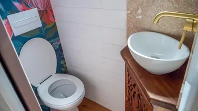 a bathroom with a toilet and a sink at Les Cabanes d'ErbeFol in Ansignan