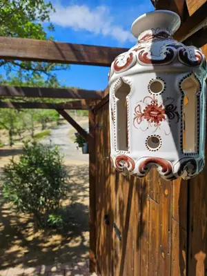 a lantern on the side of a wooden fence at Les Cabanes d'ErbeFol in Ansignan