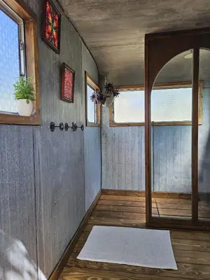 an empty room with a door and a window at Les Cabanes d'ErbeFol in Ansignan
