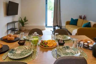 a table with plates of food on top of it at Le rempart Scandinave - Triplex au pied de la Cité in Carcassonne