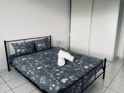a bed with two white shoes sitting on it at Appartement 3 chambres proche centre ville in Carcassonne