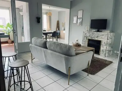 a living room with a couch and a fireplace at Appartement 3 chambres proche centre ville in Carcassonne