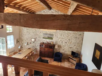 a bedroom with a bed and a stone wall at Le Clos Sainte Marie - Lampy in Cenne-Monestiès