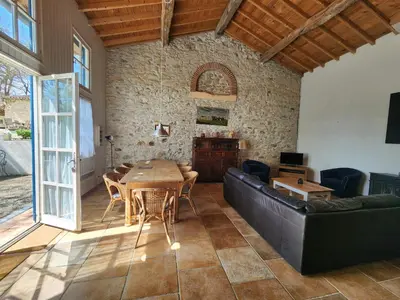 a living room with a table and a couch at Le Clos Sainte Marie - Lampy in Cenne-Monestiès