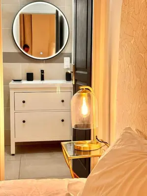 a bedroom with a dresser and a mirror at Élégance Lauragaise * Wifi * Netflix * Terrasse in Villefranche-de-Lauragais