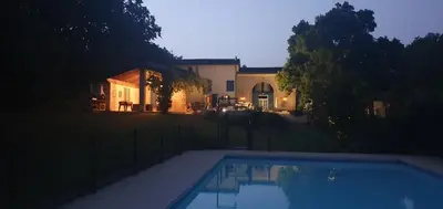 a swimming pool in front of a house at Le Clos Sainte Marie - Caune in Cenne-Monestiès