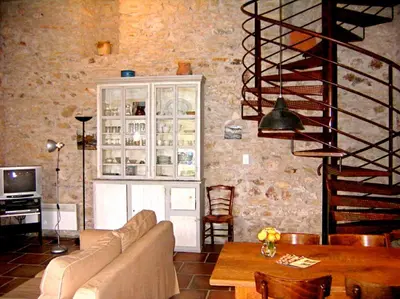 a living room with a couch and a table at Le Clos Sainte Marie - Caune in Cenne-Monestiès