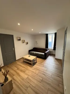 a living room with a bed and a coffee table at Jiovanni in Rieux-Minervois