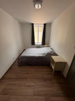 a small bedroom with a bed and a window at Jiovanni in Rieux-Minervois
