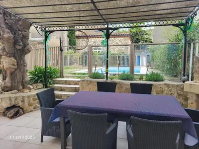 a purple table and chairs on a patio at Gîte des Vignerons in Salles-d'Aude