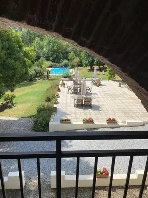 a view of a patio with chairs and tables at Le Clos sainte Marie - Crouzette in Cenne-Monestiès