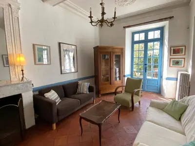 a living room with a couch and a table at Maison d'hôtes La Giraudasse in Soulatgé