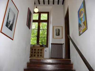 a staircase in a house with a window and a stair case at Maison d'hôtes La Giraudasse in Soulatgé