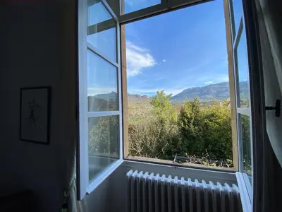 a window with a view of a mountain view at Maison d'hôtes La Giraudasse in Soulatgé
