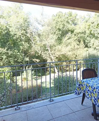 a living room with a couch in front of a window at Les Murmures du Lac in Azille