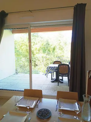 two beds with red and black pillows in a bedroom at Les Murmures du Lac in Azille