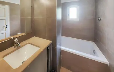 a bathroom with a sink and a bath tub at 2 Bedroom Nice Home In Saint-Laurent-De-La-Ca in Saint-Laurent-de-la-Cabrerisse