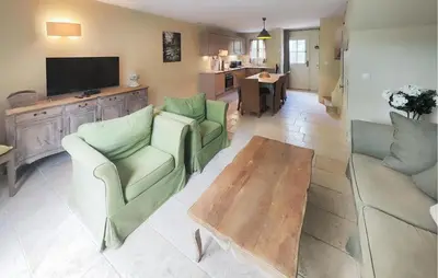 a living room with two chairs and a coffee table at 2 Bedroom Nice Home In Saint-Laurent-De-La-Ca in Saint-Laurent-de-la-Cabrerisse
