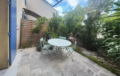 a white table and chairs on a patio at 2 Bedroom Nice Home In Saint-Laurent-De-La-Ca in Saint-Laurent-de-la-Cabrerisse
