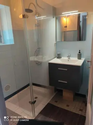 a bathroom with a glass shower and a sink at gite 4 pers a ROUZE in Rouze