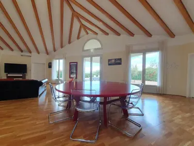 a living room with a table and chairs at Le Ranch in Oupia