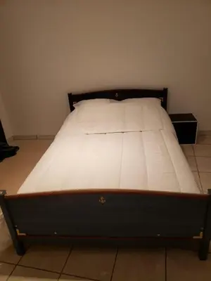 a bed in a room with a white mattress at Maison meublée avec garage in Pamiers