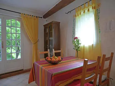 a dining room table with a bowl of fruit on it at Villa in Pyrenees with Stunning Mountain Views in Fenouillet