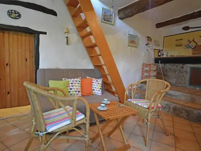 a living room with chairs and a couch and a staircase at Villa in Pyrenees with Stunning Mountain Views in Fenouillet