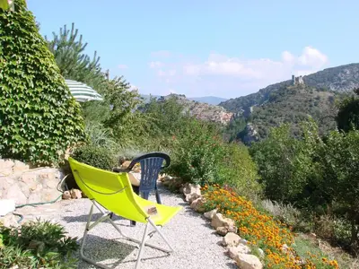 two chairs sitting on a gravel patio with a view of a mountain at Villa in Pyrenees with Stunning Mountain Views in Fenouillet