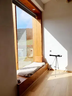 a window in a room with a bed and a desk at La ferme - Domaine Monbel in Mirepoix