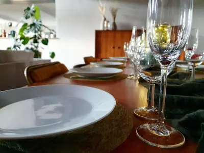 a table with plates and wine glasses on it at La ferme - Domaine Monbel in Mirepoix