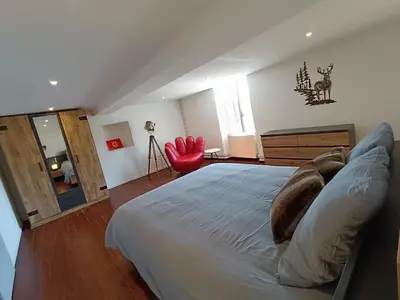 a bedroom with a bed with a seal on the pillows at La ferme - Domaine Monbel in Mirepoix