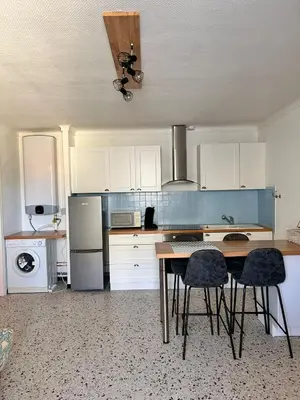 a kitchen with a table and chairs in it at Les sables d'or in Port-la-Nouvelle