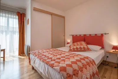 a bedroom with a bed and a large window at Maison avec piscine privée à La Digne-d'Aval in La Digne-dʼAval