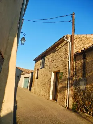 an alley with an old building and a street light at Maison avec piscine privée à La Digne-d'Aval in La Digne-dʼAval