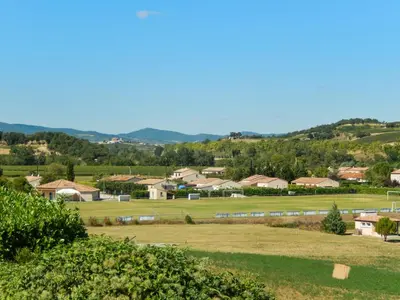 a view of a town with a field and houses at Maison avec piscine privée à La Digne-d'Aval in La Digne-dʼAval