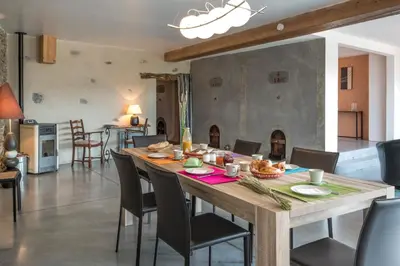 a dining room with a wooden table and chairs at Maison avec piscine privée à La Digne-d'Aval in La Digne-dʼAval