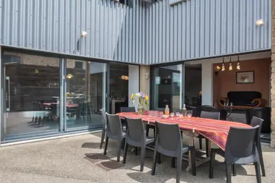 a dining room table with chairs and a red table cloth at Maison avec piscine privée à La Digne-d'Aval in La Digne-dʼAval