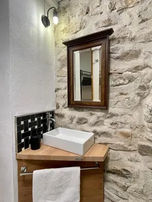 a doorway into a building with a mirror at Chambre Le 40 marches in Cucugnan