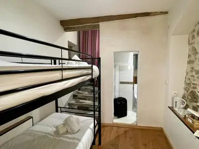 a bathroom with a sink and a mirror on a stone wall at Chambre Le 40 marches in Cucugnan