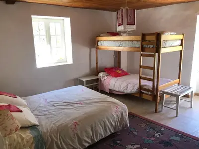 a bedroom with two bunk beds and a ladder at Maison de campagne Les loirs in Lespinassière