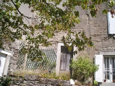 an old brick building with a door and a window at Maison de campagne Les loirs in Lespinassière