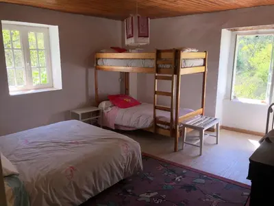 a bedroom with two bunk beds and a bed at Maison de campagne Les loirs in Lespinassière